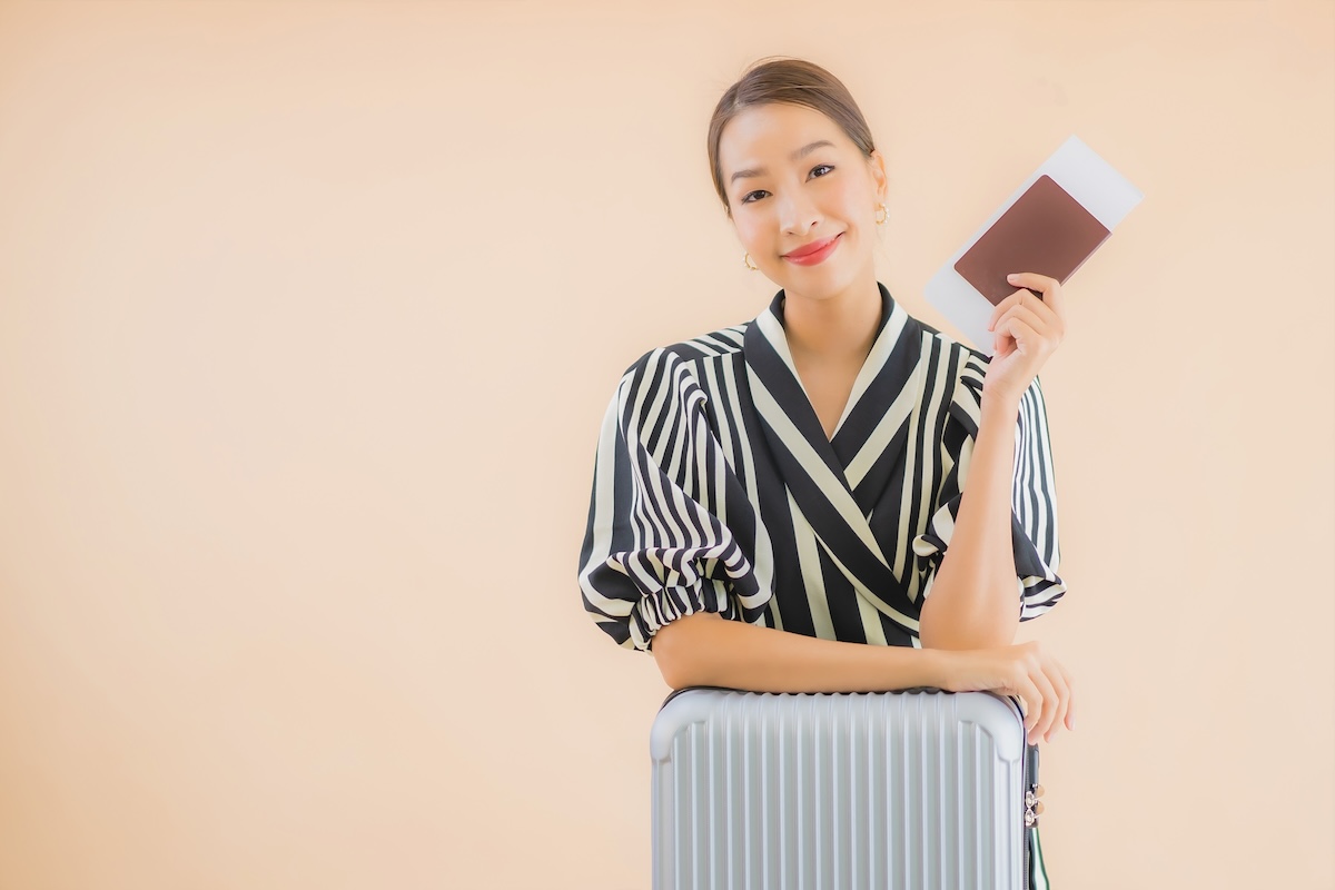 Portrait beautiful young asian woman with luggage bag passport